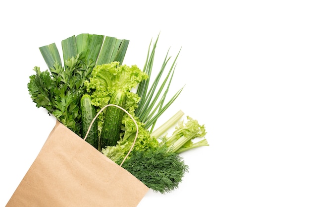 A set of green products in a paper bag. isolated on white background. shopping in a supermarket or market