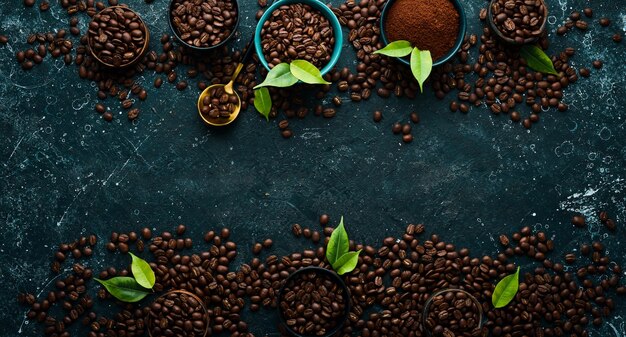 Set of ground coffee and coffee beans on a black stone background Top view Free space for text