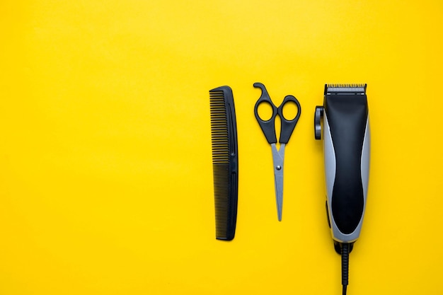 Set for a hairdresser on a yellow background. Top view. Copy, empty space for text