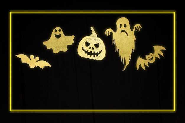 Set di simboli di halloween al neon dorato di halloween per la festa. zucca spaventosa alla moda dorata, ragno, pipistrello, fantasma e mummia su sfondo di legno scuro.