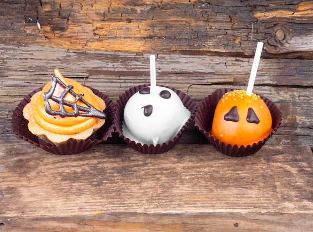 Set of Halloween sweets on old wooden background