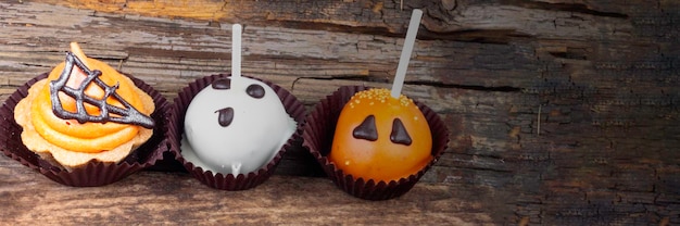 Set of Halloween sweets on old wooden background