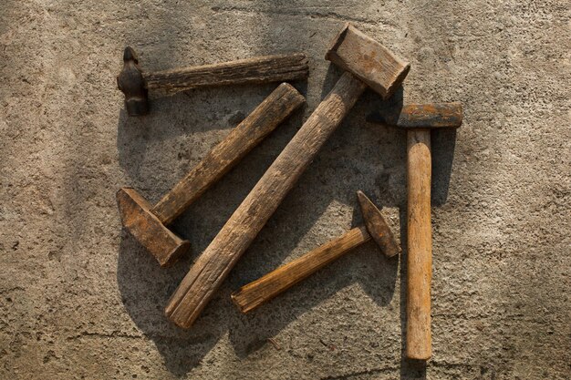 Set of hammers of different sizes on concrete pavement