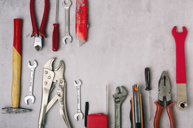 Set of hand tools on a stone gray panel close up, top view