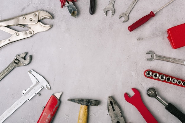 Set of hand tools on a stone gray panel close up, top view