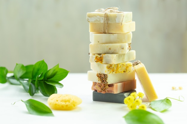 Set of handmade soaps with herbal material green leaves