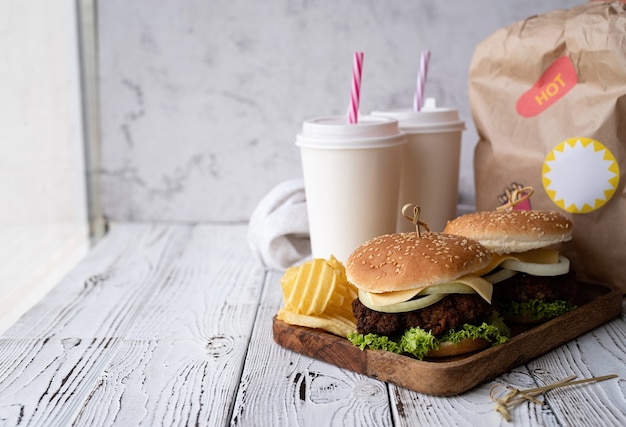 Set of homemade burgers chips and drink