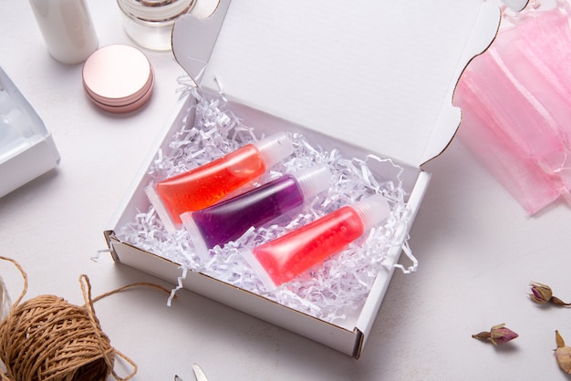 Set of homemade lip gloss in cardboard box