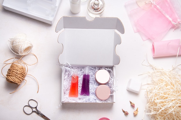 Photo set of homemade lip gloss in cardboard box