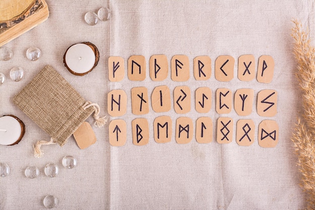 A set of homemade runes made of cardboard lies in rows on the table top view