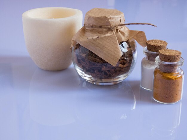 Set ingredients and spice for aromatherapy and body care on a white surface with reflection