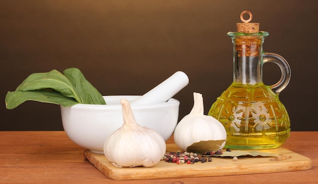 Set of ingredients and spice for cooking on wooden table on brown background