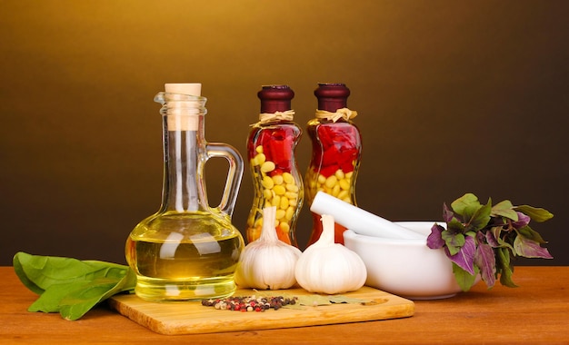 Set of ingredients and spice for cooking on wooden table on brown background