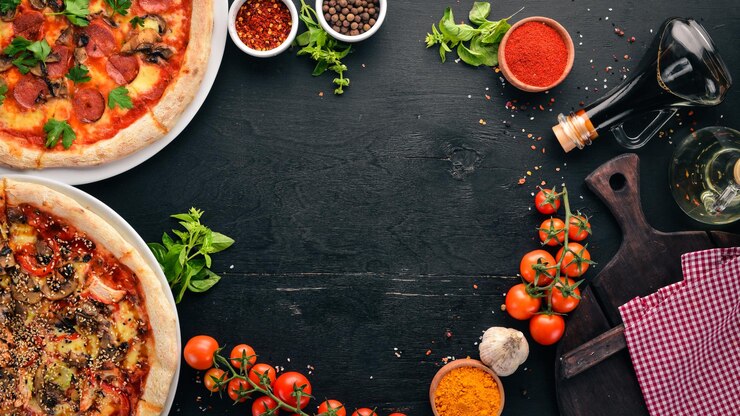 A set of Italian pizza Italian cuisine On a black wooden background Free copy space Top view
