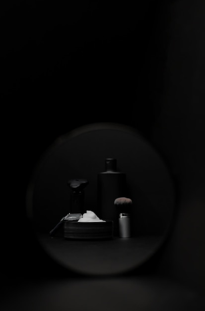 A set of items for shaving a beard on a black background