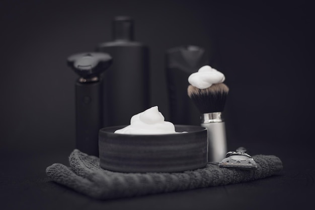 A set of items for shaving a beard on a black background