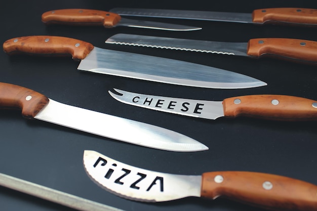 Set of kitchen knives with wooden handle top view close up
