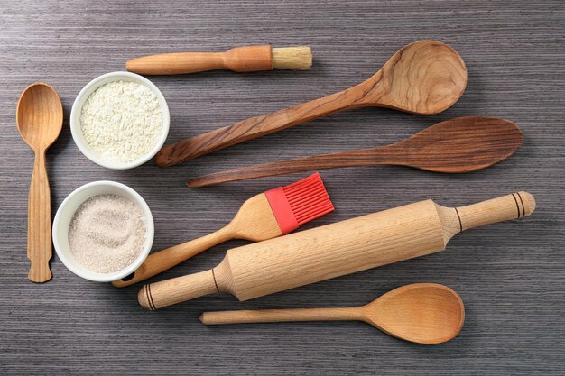 set of kitchen utensils with products on wooden background cooking master classes