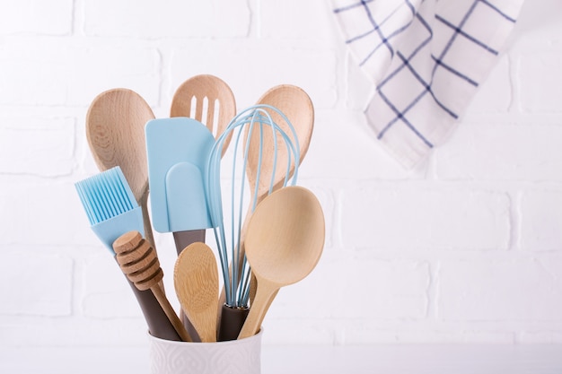 Set of kitchen utensils, wooden and silicone, free copy space . Close up