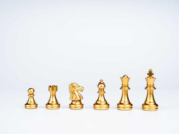 Set of luxury golden chess pieces isolated on white background The photo of gold chess king rook bishop queen knight and pawn