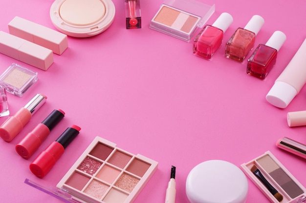 A set of makeup tools and a pink background