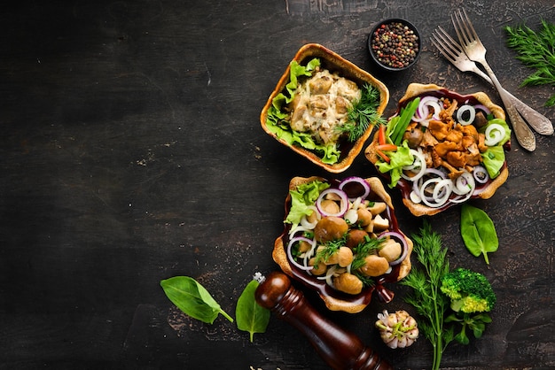 Set Marinated mushrooms with onions and spices in a plate on rustic background top view banner