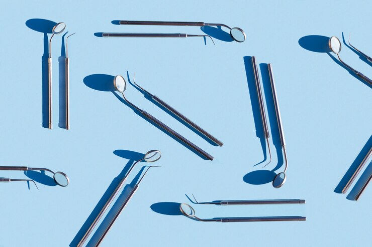Set medical dental tool blue background. pattern. mirror probe treatment, hygiene, examination oral cavity.
