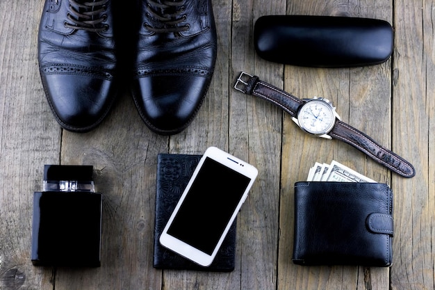 A set of men's things from shoes and a smartphone with a watch