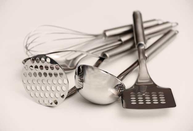 Photo set of metal kitchen utensils on table