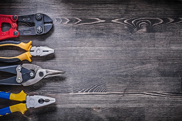 Set of metal wire steel cutter pliers on wooden background