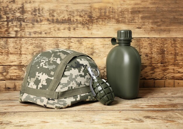 Set of military outfit on wooden background close up