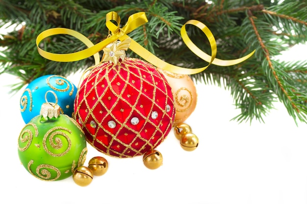 Set of multicolored christmas balls with fir tree branch isolated on white background