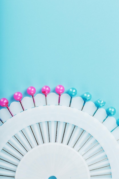 A set of multicolored needles pins in a round platform