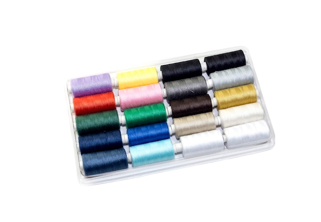 Set of multicolored new sewing threads in a package on a white background closeup