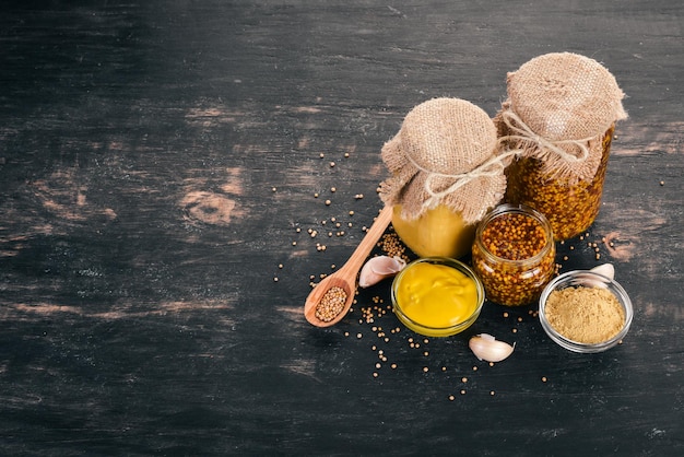 A set of mustard and spice On a wooden background Top view Copy space for your text