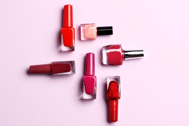 a set of nail polishes on a lilac background