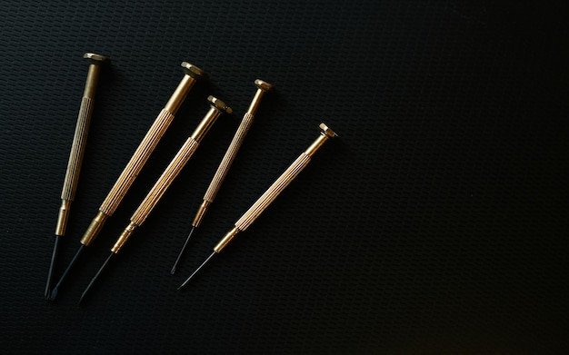 A set of nails on a black background