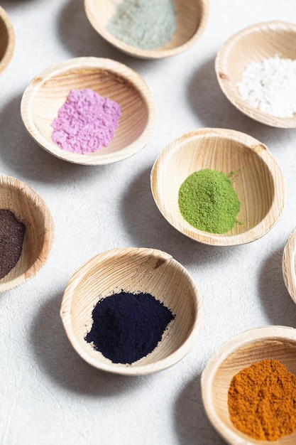 Set of natural pigment powder from herbs in small bowls