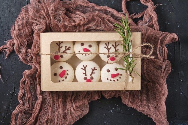 Photo set of new year pastries macarons with tangerine filling white chocolate and cream