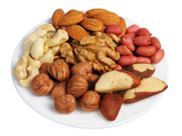 Set of nuts on a white plate isolated