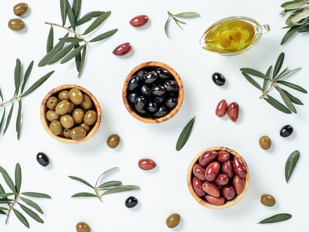 Set of olives and olive oil on white background