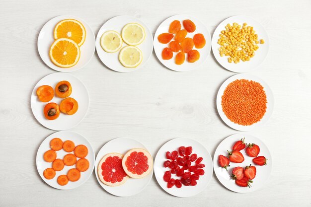 Set of orange products on wooden background