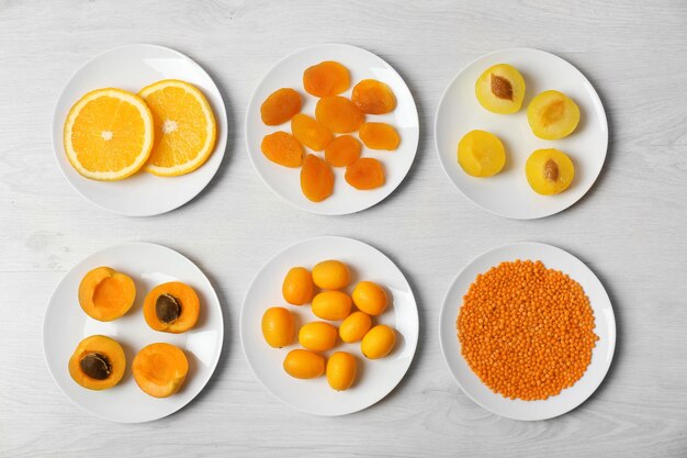 Set of orange products on wooden background