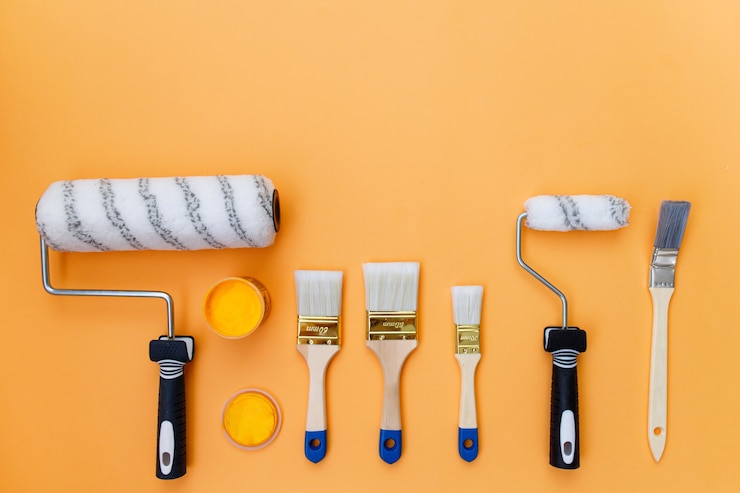 Photo set of paintbrushes on an orange background