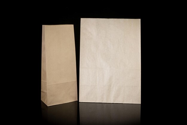 Photo set of paper bags for shopping on black background mockup for design