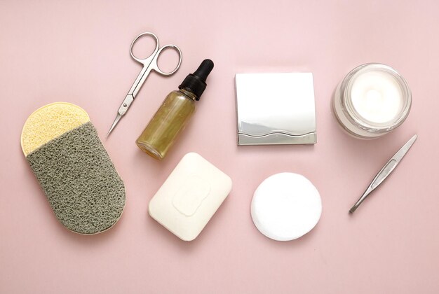 Set of personal care accessories on a pale pink background