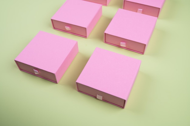 Set of pink cardboard boxes on pastel green background. High quality photo