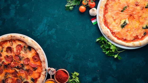 A set of pizza Italian cuisine On a black stone background Free copy space Top view