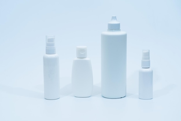 Set of plastic bottles containers for cosmetics on white\
background