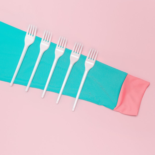 Set of plastic forks and sleeves. pastel colors. minimalism art.